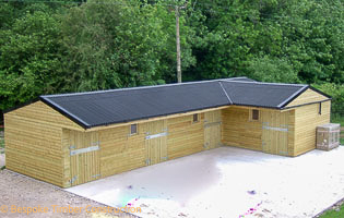 L-Shaped stable block with horizontal cladding